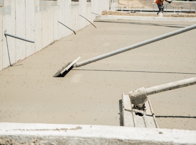 A construction worker is working on the side of a building.